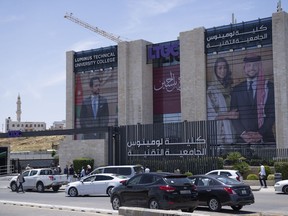 Posters with pictures of Crown Prince Hussein and his fiancee, Saudi architect Rajwa Alseif, hangs at the entrance of the Luminus Technical University in Amman, Jordan, Tuesday, May 30, 2023. Crown Prince Al Hussein bin Abdullah II, 28, and Rajwa Alseif, 29, are to be married Thursday at a palace wedding in Jordan, a Western-allied monarchy that has been a bastion of stability for decades as Middle East turmoil has lapped at its borders.
