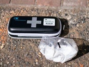 A program that is the first of its kind in Canada aims to help British Columbians living with mild to moderate overdose-related brain injuries. The Cognitive Assessment and Rehabilitation for Substance Use program provides specialized supports for people who use substances including opioids and alcohol. A used naloxone kit is seen on the sidewalk as paramedics respond to a drug overdose in downtown Vancouver on June 23, 2021.