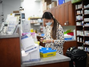 Pharmacist Cathy Wang works at the 360Care Denman Pharmacy in Vancouver, B.C., Monday, Oct. 3, 2022. New data from the provincial government show there was a 120 per cent increase in the number of residents renewing or adjusting prescriptions after pharmacists were given expanded prescribing powers.