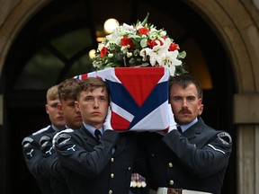 Pallbearers carry the coffin of WW2 Royal Air Force (RAF) pilot Flight Sergeant Peter Brown out of St Clement Danes Church in central London on May 25, 2023, following his funeral service.