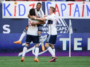 Vancouver Whitecaps FC midfielder Pedro Vite (45) celebrates his goal with forward Brian White (24) and midfielder Julian Gressel (19) against the Houston Dynamo FC during the first half at B.C. Place.
