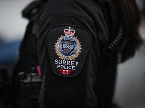 A Surrey police patch is seen on an officer's jacket