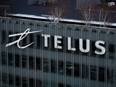 The Telus Corporation logo is seen on the outside of the company's headquarters in downtown Vancouver, on Thursday, January 19, 2023. Telus says it's offering buyouts to a large group of employees and anticipates several hundred workers will take them.