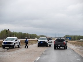 Police block the road into the wildfires near Entwhistle Alberta on Sunday May 7, 2023. Environment Canada has blanketed all of Alberta and most of British Columbia in special heat advisories as temperatures are expected to be up to 15 degrees above normal over the next several days.