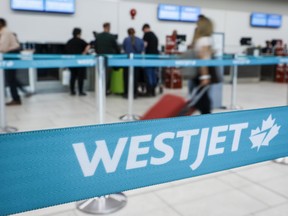 A line at the WestJet counter at the airport in Calgary, Alta., Thursday, May 18, 2023.