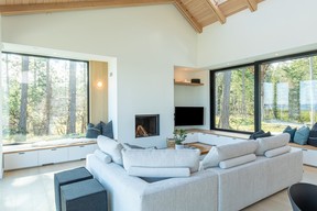 Sliding glass doors and windows open on either side for indoor-outdoor living. Cushions and accessories are from Provide Home, sectional from Brougham Interiors