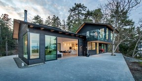 This 2,800-square-foot, three-bedroom home in Nanoose Bay, Vancouver Island, was designed to fit with the natural shape of its coastal lot, disturbing the landscape as little as possible with minimal excavation. Builder Alair Homes retained and protected a large Garry oak within the concrete patio.