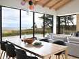 Vaulted ceilings with fir beams and ridge skylights add to the home's air of spaciousness, while wide-plank white oak flooring ties together the spaces with a modern but warm feel.