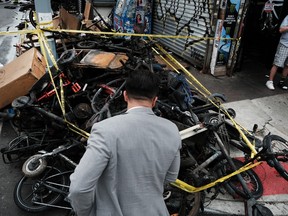 Charred remains of e-bikes and scooters sit outside of a building in New York after four people were killed by a fire in an e-bike repair shop on June 20, 2023 .