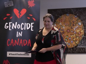 Native Women's Association of Canada CEO Lynne Groulx takes her seat after speaking during an event launching a graphic guide to genocide, in Ottawa, Monday, June 19, 2023. The Native Women's Association of Canada says the ongoing genocide of Indigenous peoples should be part of Canadian high school curriculums, and the organization has developed a graphic guide to help teach students about it.