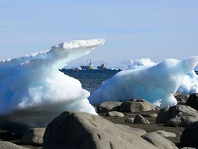 Ships are framed by pieces of melting sea ice on Frobisher Bay in Iqaluit, Nunavut, on July 31, 2019. Canada is closing its Arctic centre headquarters and relocating it to Ottawa.