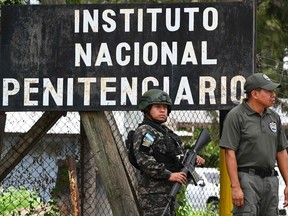 Honduran soldiers guard the facilities of the Women's Center for Social Adaptation (CEFAS) prison after a fire on June 20.