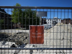 A sign opposing a condo project at 105 Keefer Street in Vancouver's Chinatown is seen on a fence at the proposed site on Tuesday, June 6, 2023. Vancouver's development permit board has approved the controversial nine-storey residential tower in the heart of the city's Chinatown, capping a years-long battle between the developer and the city.