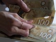 Canadian $100 bills are counted in Toronto, Feb. 2, 2016. With more and more Canadians set to retire in the coming years, tens of thousands of people are eyeing their retirement savings amid high inflation and interest rates.&ampnbsp;THE CANADIAN PRESS/Graeme Roy