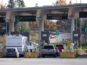 Motorists wait at U.S. Customs and Border Protection inspection booths at the Peace Arch border crossing in Blaine, Wash., across the Canada-U.S. border from Surrey, B.C., on Monday, Nov. 8, 2021. Cross-border shopping buses filled with Chinese and Korean Canadian consumers were once ubiquitous outside Washington state malls, but they have all-but disappeared from the commercial landscape, dealing a hard blow to border-town businesses.