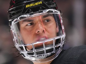 Vancouver Canucks' Ethan Bear wears a full face shield as he waits for a faceoff during the second period of an NHL hockey game against the Vegas Golden Knights in Vancouver, on Tuesday, March 21, 2023. The Canucks say Bear has undergone successful shoulder surgery and is expected to be out for six months.
