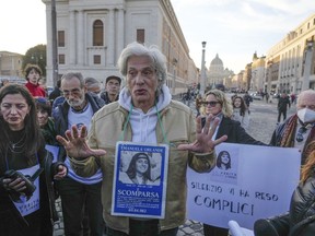 FILE - Pietro Orlandi wears a placard with a picture of his sister Emanuela during a sit-in near Saint Peter's Basilica, in Rome, Saturday, Jan. 14, 2023. The Vatican marked the 40th anniversary of the disappearance of the teenage daughter of a Vatican employee by confirming the existence of new leads "worthy of further investigation" in hopes of finally getting to the bottom of one of the Holy See's enduring mysteries.