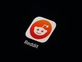FILE - The Reddit app icon is seen on a smartphone on Feb. 28, 2023, in Marple Township, Pa. More than 8,000 subreddits, or Reddit communities, have gone dark as of Tuesday, June 13, in protest of upcoming API changes, which include a controversial policy that will charge some third-party apps for continued use.