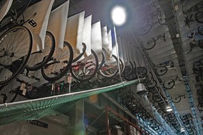 Recovered stolen bikes are literally hanging from the rafters on a conveyor system at the VPD property office in Vancouver.