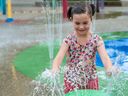 Elizabeth Salo, 6, plays at Splash Park at Rocky Point Park in Port Moody on June 29.