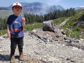 Stokely, age 4, with Sayward's Newcastle fire burning in the backdrop, has grown up in the era of climate wildfires.