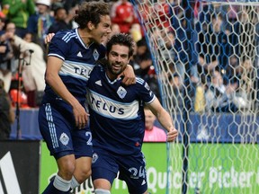 Vancouver Whitecaps FC forward Brian White celebrates his goal against CF Montreal keeper Jonathan Sirois, not pictured, with forward Simon Becher at B.C. Place on April 1.