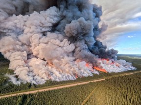 The Donnie Creek wildfire burns in an area between Fort Nelson and Fort St. John, B.C., in this undated handout photo provided by the BC Wildfire Service. Tackling British Columbia's largest-ever wildfire involves a combination of protecting homes and infrastructure, and letting it burn, the province says.