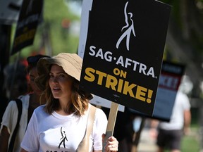 Hollywood actors, writers and their supporters walk the picket line Tuesday outside Disney Studios in Burbank, Calif.