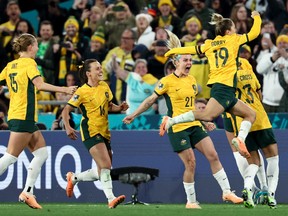 Australia's players celebrate after defender #07 Stephanie Catley scored a penalty during the Australia and New Zealand 2023 Women's World Cup Group B football match between Australia and Ireland at Stadium Australia, also known as Olympic Stadium, in Sydney on July 20, 2023.