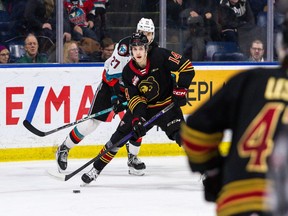 Ethan Semeniuk of the Vancouver Giants tries to pull away from the Kelowna Rockets' Dylan Wightman during a game last season.