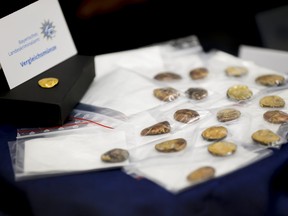 Comparison coins are presented during a press conference held by the Bavarian State Criminal Police Office and the Munich Public Prosecutor's Office on the arrests in the Manching gold treasure theft case in Munich, Germany, Thursday July 20, 2023.