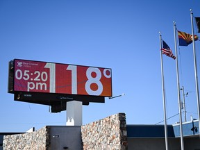 A billboard displays a temperature of 118 degrees Fahrenheit (48 degrees Celcius) during a record heat wave in Phoenix, Arizona on July 18, 2023.