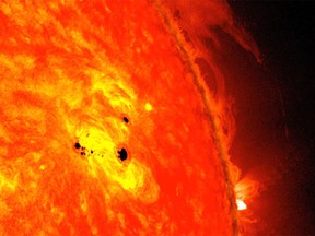 An active region on the sun with dark sunspots, which can be much larger than Earth.