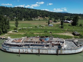 The retired BC Ferries vessel Queen of Sidney, that was in operation from 1960 to 2000, is seen moored on the Fraser River, in Mission, B.C., on Tuesday, July 18, 2023. The Canadian government's inventory of more than 1,700 wrecked, abandoned or hazardous boats includes a U.S. warship, a derelict floating McDonald's known as the McBarge, a human-smuggling ship and an old BC Ferries vessel rotting on the Fraser River.