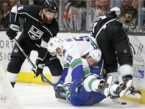 The Vancouver Canucks' Alex Biega and Nikolay Goldobin collide as they battle the Los Angeles Kings' Jake Muzzin and Alec Martinez in the second period of a 2018 pre-season game in Salt Lake City.