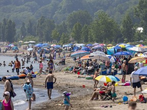 The main beach in Port Stanley, Ont., was a crowded with umbrellas as people rush to the beach in the heat on Wednesday July 5, 2023.