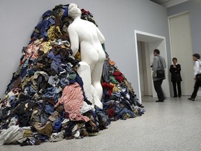 Visitors pass one of the sculptures from the series "Venus of the Rags" from Michelangelo Pistoletto in the Art and Exhibition Hall of the Federal Republic of Germany in Bonn, Germany, Thursday, Aug. 10, 2005.