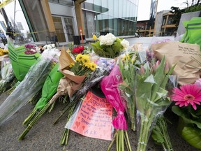 Flowers and notes are seen at a makeshift memorial outside of the Lynn Valley Library in Lynn Valley in North Vancouver, B.C., Sunday, March 28, 2021. Victims of a stabbing spree two years ago in North Vancouver told the court their lives were shattered by Yannick Bandaogo's fatal attack in and around a Lynn Valley library.