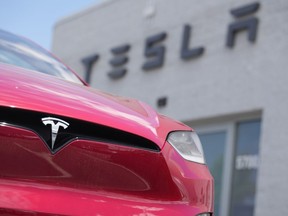 An unsold 2023 Model X sports-utility vehicle sits outside a Tesla dealership Sunday, June 18, 2023, in Littleton, Colo. Tesla earnings are reported on Wednesday.