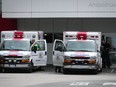Paramedics and ambulances are seen outside the emergency department at Burnaby Hospital in Burnaby, B.C., on Monday, May 30, 2022.