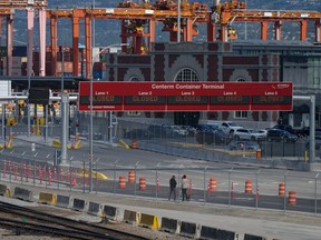 Signs displaying "closed" are seen at the Centerm Container Terminal as striking International Longshore and Warehouse Union Canada workers picket at the port, in Vancouver, B.C., Tuesday, July 11, 2023.
