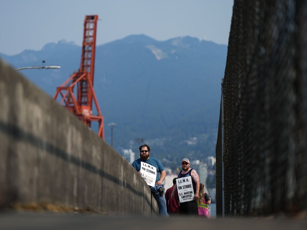 Striking International Longshore and Warehouse Union Canada workers picket at a port entrance in Vancouver, B.C., Tuesday, July 4, 2023.