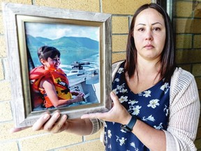 Tanisha Bonsdorf holds a picture of her son Carter Logan McMenamie Bonsdorf, who died on Aug. 24, 2019 at the age of nine.