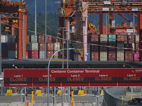 Signs displaying "closed" are seen at the Centerm Container Terminal during a strike by International Longshore and Warehouse Union Canada workers, at the port, in Vancouver, B.C., Tuesday, July 11, 2023.&ampnbsp;Railways are facing a sharp drop-off in container shipments as the strike by B.C. port workers halts more than half of steel-box cargo.