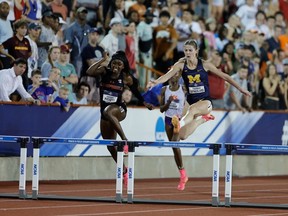 Savannah Sutherland clears a hurdle during NCAA competition in June.