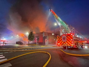 A restaurant, boutique, salon and costume shop are among the businesses believed to have been destroyed in an early morning fire. Firefighters battle a blaze in downtown Vernon, B.C., in a Tuesday, July 4, 2023, handout photo.