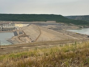Final touches are put on the earth-filled dam at the B.C. Hydro Site C electric project on the Peace River near Fort St. John, in July.