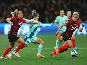 Katrina Gorry of Australia competes for the ball against Adriana Leon and Cloe Lacasse of Canada during the FIFA Women's World Cup Group B match between Canada and Australia at Melbourne Rectangular Stadium on July 31, 2023 in Melbourne, Australia. Robert Cianflone/Getty Images