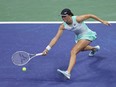 Iga Swiatek returns a shot against Aryna Sabalenka during the U.S. Open in 2022.