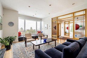A stylish stained-glass partition in the foyer and maple hardwood floors in the stylish living room.